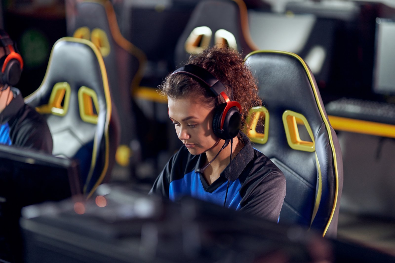 Focused teenage mixed race girl, professional female gamer
